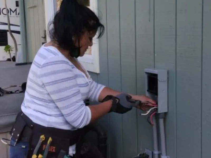 Licensed electrician wiring an exterior subpanel in Lawnside